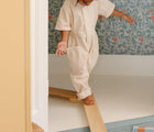 Child balancing on the Piccalio Wooden Balance Beam. Available from www.tenlittle.com