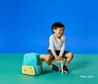 Boy age 4 sitting wearing Ten Little Everyday Original - Space Black. Available at www.tenlittle.com