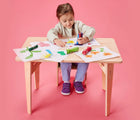 Girl coloring wearing Ten Little Everyday Original - Power Purple. Available at www.tenlittle.com