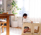 Child using the Piccalio Convertible Kitchen Tower as a table. Available from www.tenlittle.com