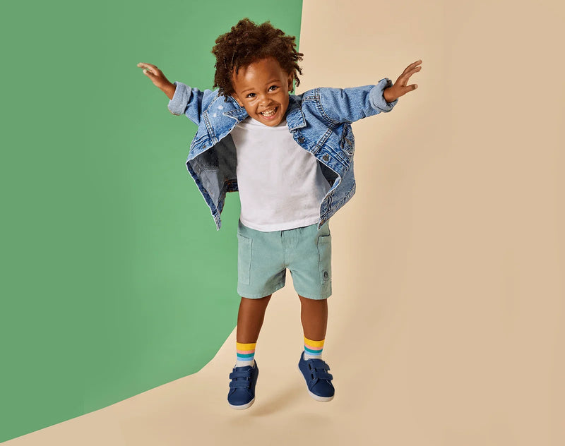 Girl jumping wearing Ten Little Everyday Original - Navy Blue. Available at www.tenlittle.com