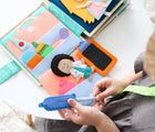Child playing with Educating Amy Medic Quiet Book. Available from www.tenlittle.com.