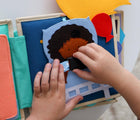 Child playing with Educating Amy Medic Quiet Book. Available from www.tenlittle.com.