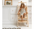 Child climbing down the Piccalio Foldable Kitchen Tower. Available from www.tenlittle.com