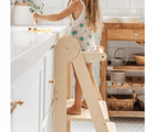 Close up of child standing on the Piccalio Foldable Kitchen Tower to reach kitchen counter. Available from www.tenlittle.com