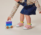Girl playing and wearing Ten Little First Walkers - Rose Pink. Available at www.tenlittle.com