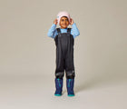Boy wearing Ten Little Snow Boots in Navy and Teal. Available at www.tenlittle.com