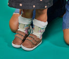 Girl wearing ten little mocha brown everyday shoe with Ten little everyday shoe mocha brown with Ten Little Velcro Strap Extenders Mocha Brown - Available at www.tenlittle.com