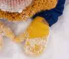 Child playing snow wearing Jan & Jul Knit Mittens in mustard. Available from tenlittle.com