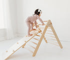 Child playing on the Piccalio Climber Pikler Triangle Set. Available from www.tenlittle.com
