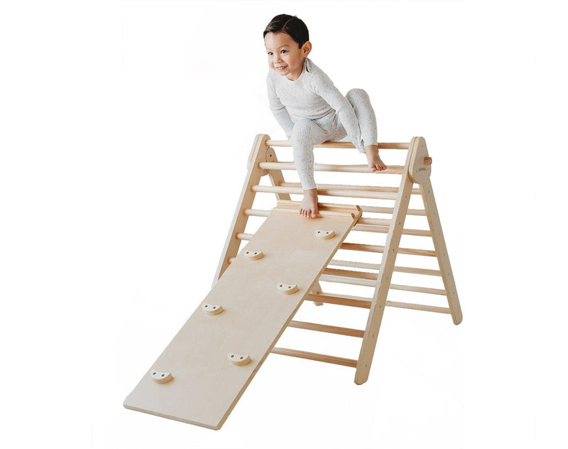 Child playing on the Piccalio Climber Pikler Triangle Set. Available from www.tenlittle.com