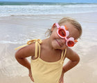 Girl at beach wearing Sunnylife Swim Goggles - Cherry. Available at www.tenlittle.com