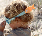 Child at beach wearing Sunnylife Swim Goggles - Fish. Available at www.tenlittle.com