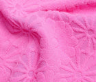 Close up texture and flower pattern of Snapper Rock One Piece UPF 50+ Swimsuit - Pink. Available at www.tenlittle.com