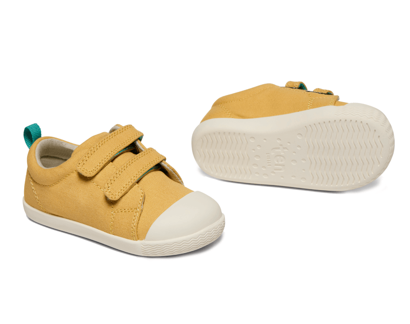 Side and bottom of shoe view of Ten Little Eco Canvas Sneakers - Mellow Yellow. Available at www.tenlittle.com
