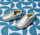 Side and front view of Ten Little Slip-On Sneakers - Moondust Silver. Available at www.tenlittle.com