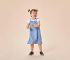 Child wearing Ten Little Slip-On Sneakers - Navy Blue. Available at www.tenlittle.com