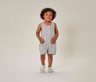 Child wearing Ten Little Slip-On Sneakers - Moondust Silver. Available at www.tenlittle.com
