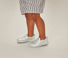 Child wearing Ten Little Slip-On Sneakers - Moondust Silver. Available at www.tenlittle.com