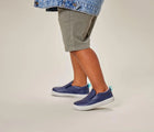 Child wearing Ten Little Slip-On Sneakers - Navy Blue. Available at www.tenlittle.com