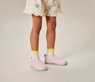 Child wearing Ten Little Slip-On Sneakers - Blush Pink. Available at www.tenlittle.com