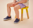 Girl wearing Ten Little Slip-On Sneakers - Navy Blue. Available at www.tenlittle.com