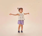 Child playing with bubbles wearing Ten Little Slip-On Sneakers - Navy Blue. Available at www.tenlittle.com