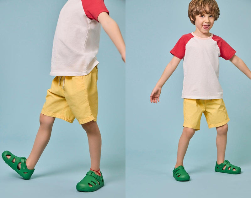 Split view of boy wearing Ten Little Splash Sandals 2 - Dino Green. Available at www.tenlittle.com