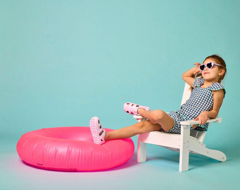 Girl sitting wearing Ten Little Splash Sandals 2 - Lavender Purple. Available at www.tenlittle.com