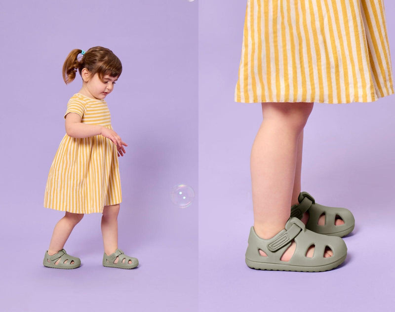Split view of girl playing with bubbles and wearing Ten Little Splash Sandals 2 - Pebble Gray. Available at www.tenlittle.com