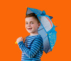 Child holding the Floss & Rock Color Changing 3D Umbrella - shark. Available from www.tenlittle.com