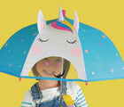 Child holding the Floss & Rock Color Changing 3D Umbrella - unicorn. Available from www.tenlittle.com