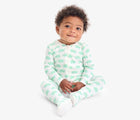 Baby sitting wearing Primary Baby Onesie PJs - 2 Pack - Clover Turtles. Available at www.tenlittle.com
