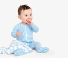 Baby sitting with blanket wearing Primary Baby Onesie PJs - 2 Pack - Steam Sheep. Available at www.tenlittle.com