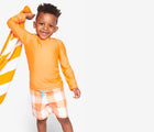 Child wearing Primary Long Sleeve Rash Guard in Cantaloupe - 2 Pack - Blueberry / Cantaloupe. Available at www.tenlittle.com