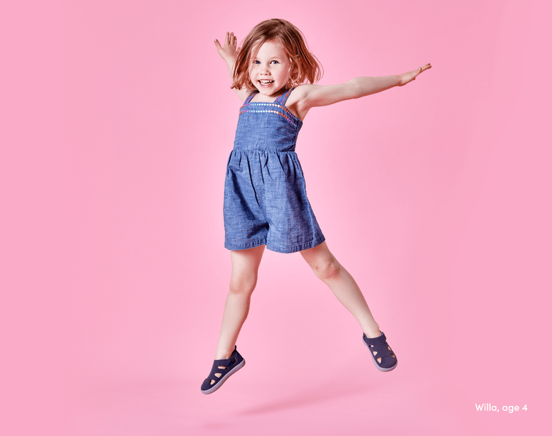 Girl age 4 jumping wearing Ten Little Everyday Sandals 2 - Slate Blue. Available at www.tenlittle.com