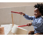 Child playing PlanToys Drum Set. Available from www.tenlittle.com.