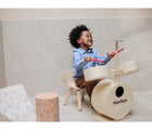 Child playing PlanToys Drum Set. Available from www.tenlittle.com.