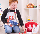 Boy playing with Bigjigs Doctor Kit. Available from www.tenlittle.com.