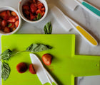 Tovla jr knives cutting strawberries on a cutting board. Available from www.tenlittle.com