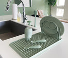 Ezpz Drying Rack in sage beside the wash area. Available at www.tenlittle.com