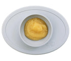 ezpz Tiny Bowl in White with food inside. Available at www.tenlittle.com