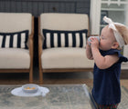 Baby Drinking in Ezpz Tiny Cup Grey with Tiny bowl in grey.  Available at www.tenlittle.com
