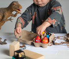 Child playing with Eco-kids Dino Eggs Beeswax Crayons. Available from tenlittle.com