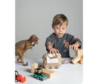Child playing with Eco-kids Dino Eggs Beeswax Crayons. Available from tenlittle.com