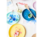 Eco-kids Milk Paint being used with plates and spoons. Available from tenlittle.com