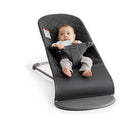 Child sitting in BabyBjörn Bouncer Bliss Cotton in anthracite classic quilt. Available from tenlittle.com