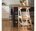 All Circles Toddler Tower in natural underneath counter in the kitchen. Available from tenlittle.com