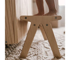 Child standing on All Circles One Step Stool in playroom. Available from tenlittle.com