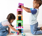 Two children playing with Ooly Stackable Toy & Car Set Rainbow Town. Available from tenlittle.com